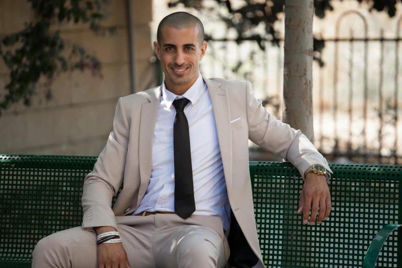 a man in a suit sitting on a bench