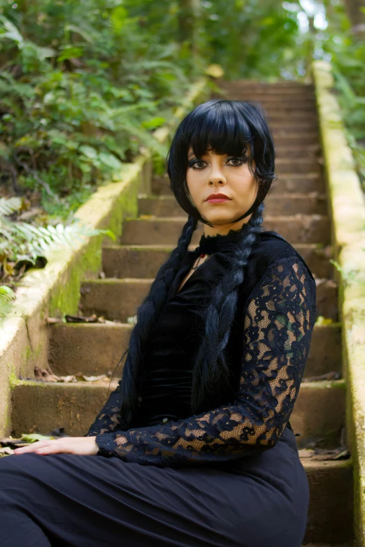 woman in black outfit sitting on a set of steps