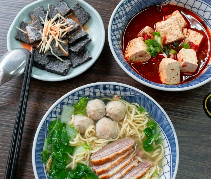 a table topped with bowls filled with food and bowls