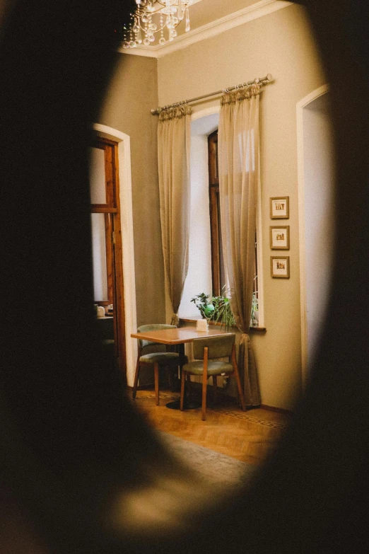 looking out from the entrance to a living area, through a circle shaped window