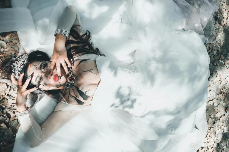 a woman laying on a rock surrounded by snow