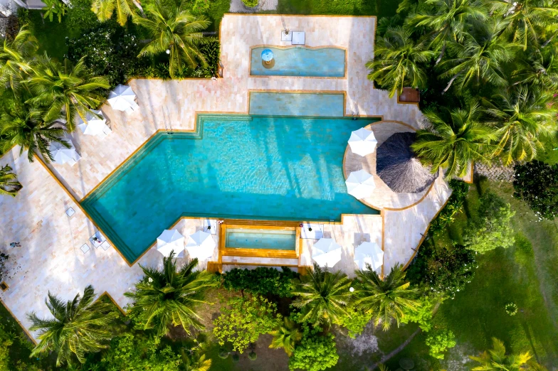 an aerial s of a backyard and pool with lounge chairs