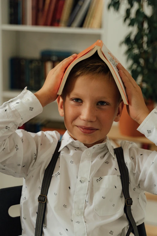 a child is smiling and holding onto a book