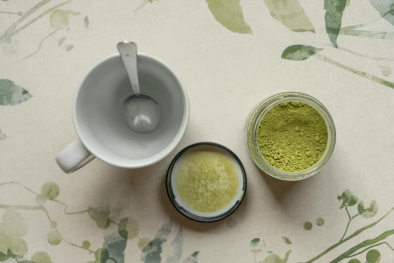 the tea bag is next to a mug of matcha