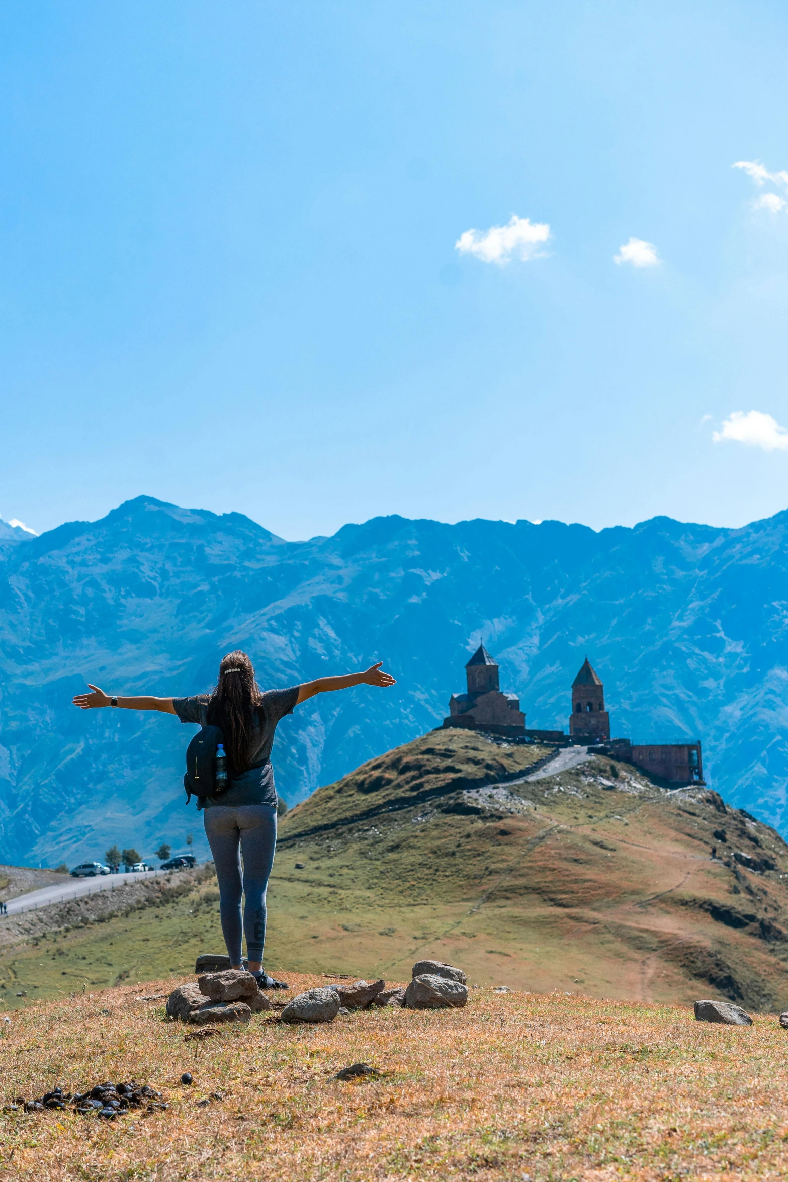 there is a woman standing on the top of a hill