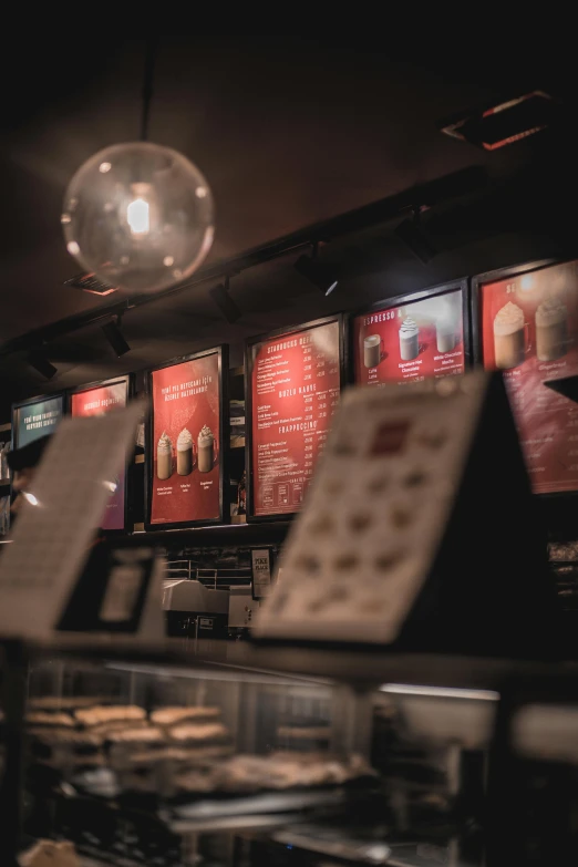 a view through the window of a bakery with red menus