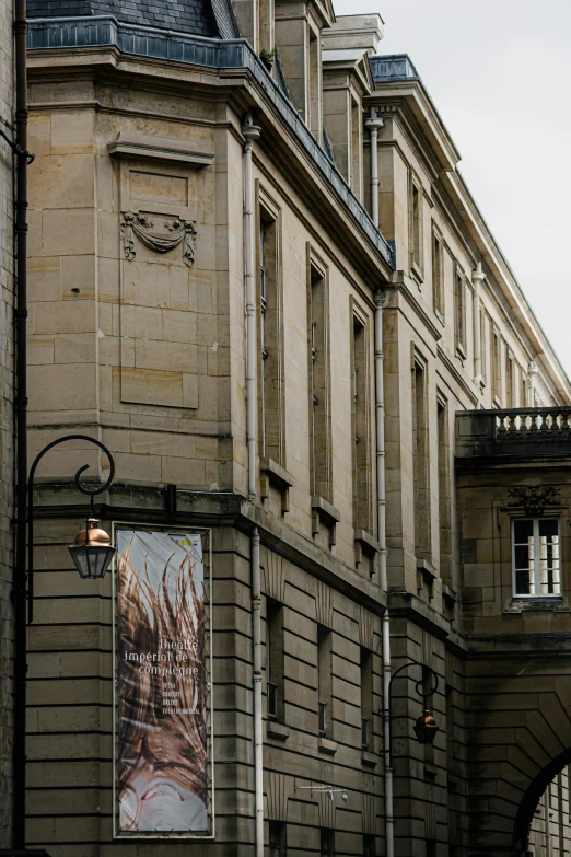 this is an old building with a poster on it