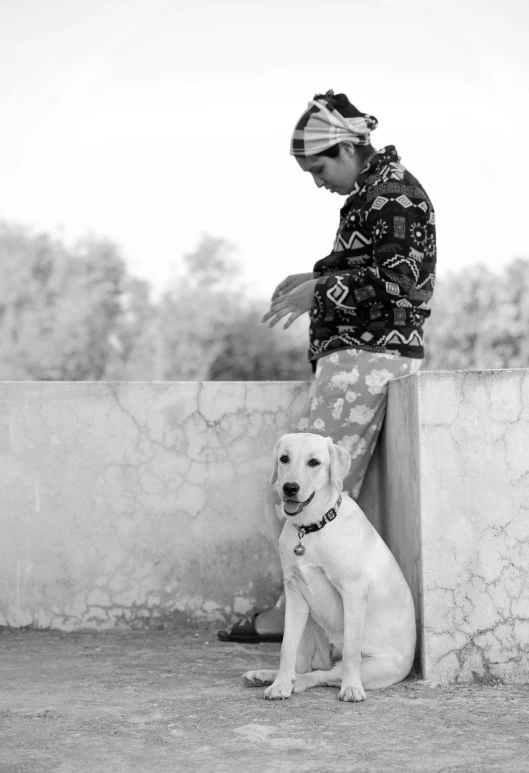 black and white pograph of woman sitting with dog