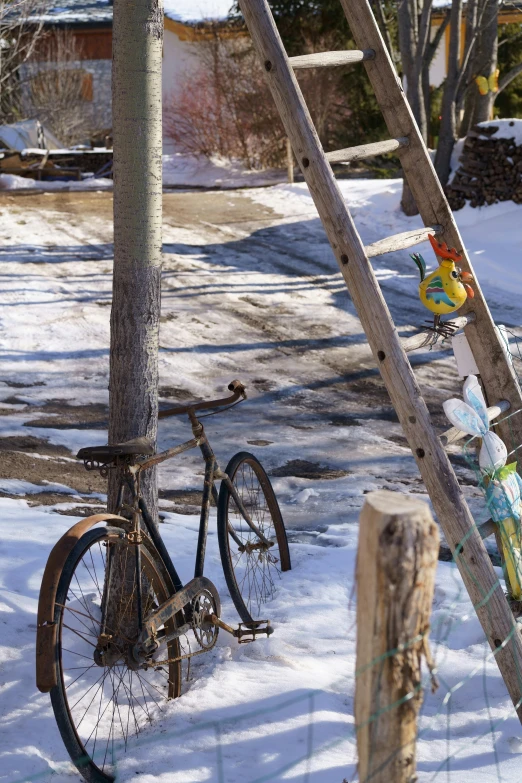 a rusty bike  up to a wooden post