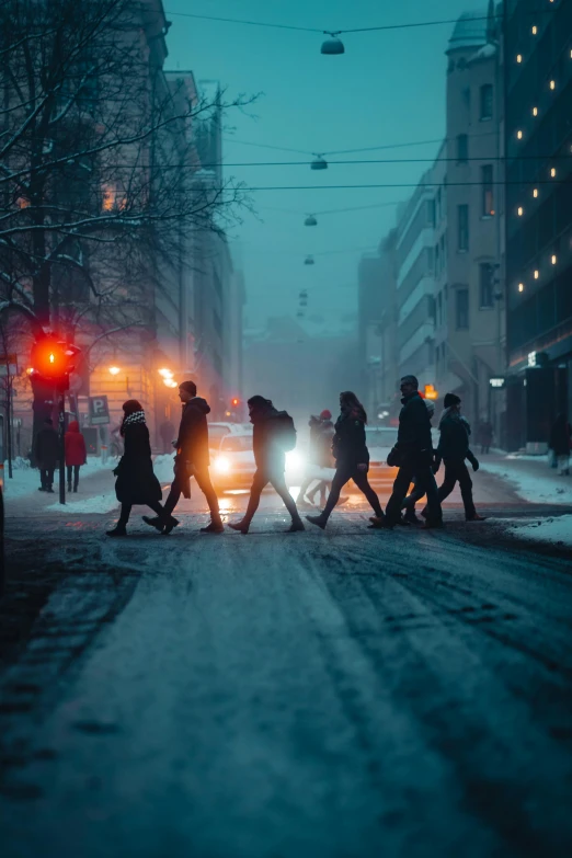 a group of people crossing the street on the crosswalk