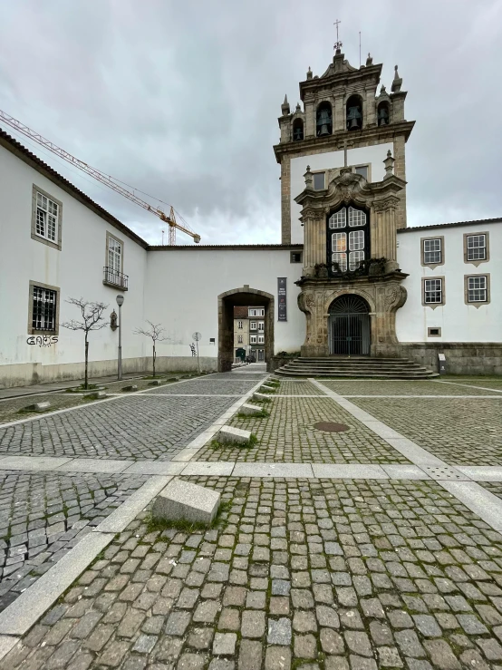 an old white building with a huge tower with multiple windows