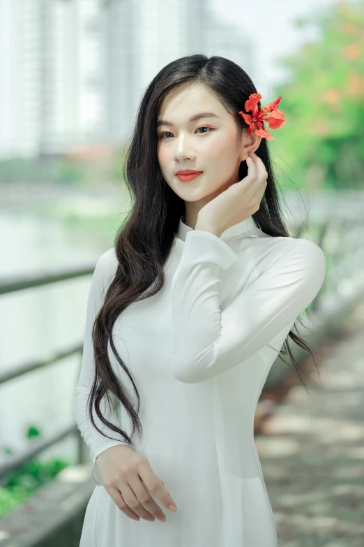 a beautiful woman with long black hair in white dress posing for a portrait