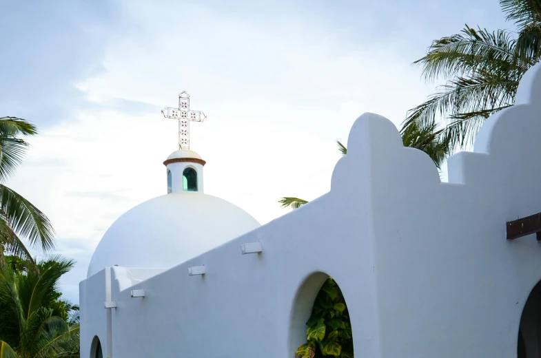 an old white church with a green dome