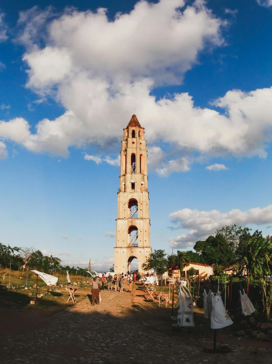 a large clock tower sitting in the middle of a field