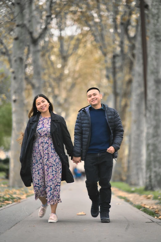 two people walking down the sidewalk together