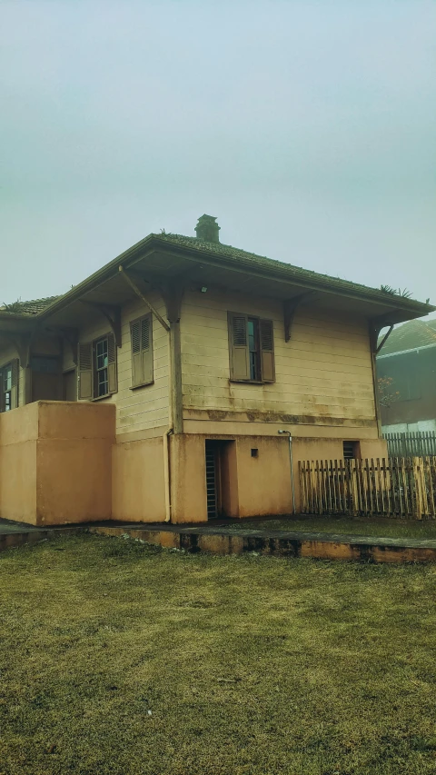 a very small building sitting on top of a field