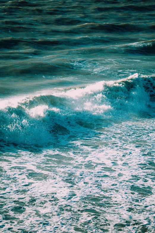 some blue colored water waves and white foam