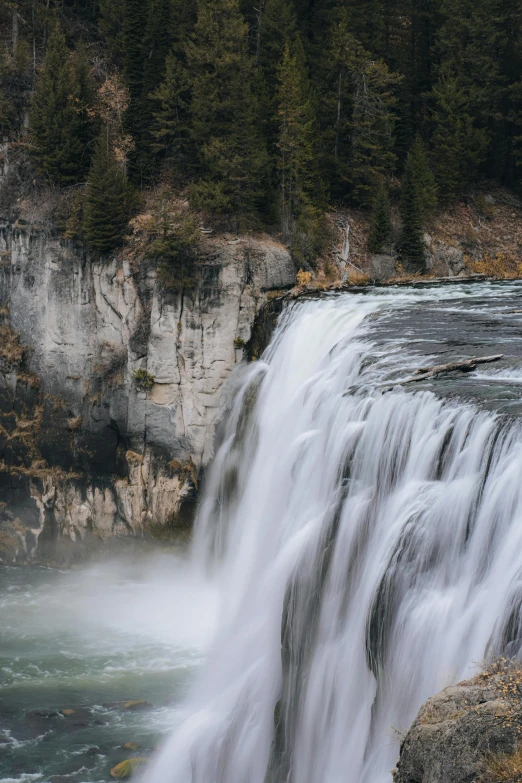 a large waterfall falls into a pool of water