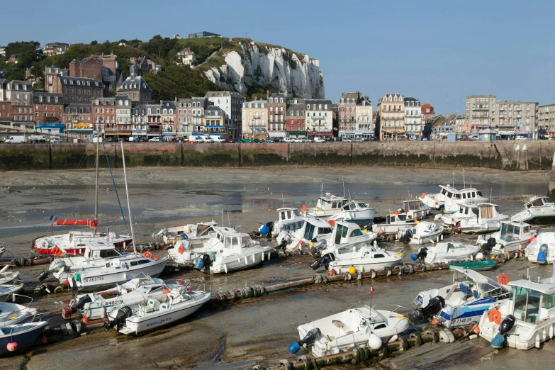 many boats are docked along the water in a marina