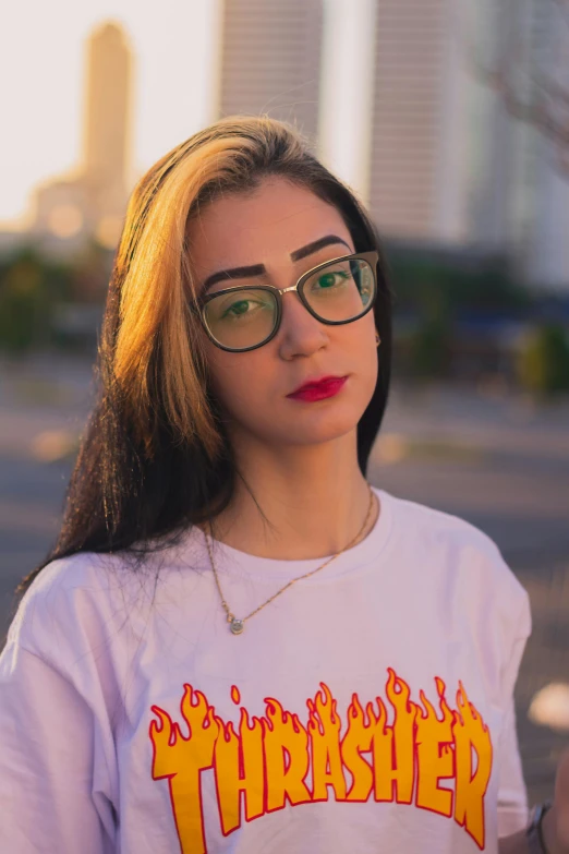 a woman in a white fireish sweatshirt and glasses
