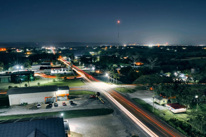 some cars driving down the street at night