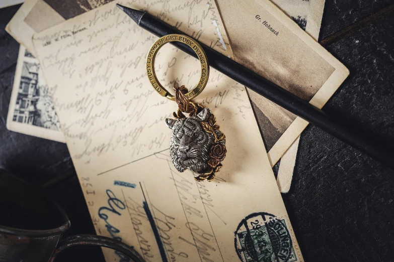 an owl key chain with two keys is on a piece of paper