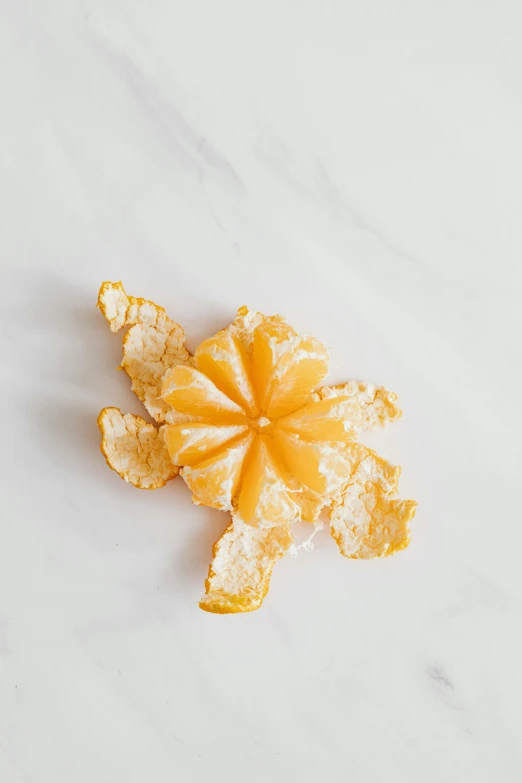 an orange peel sitting on top of a white counter