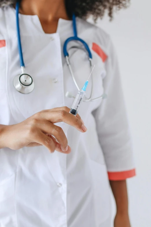 a person in white shirt holding a hospital nurse uniform