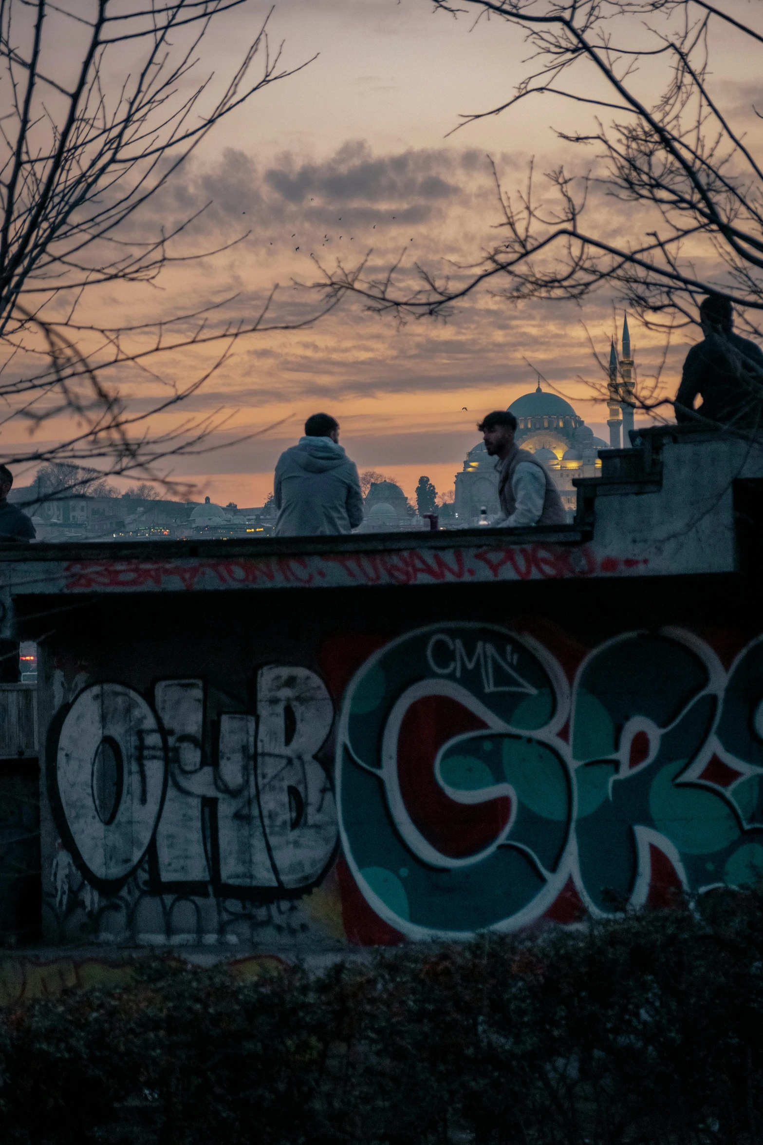 some people are gathered at a skate park