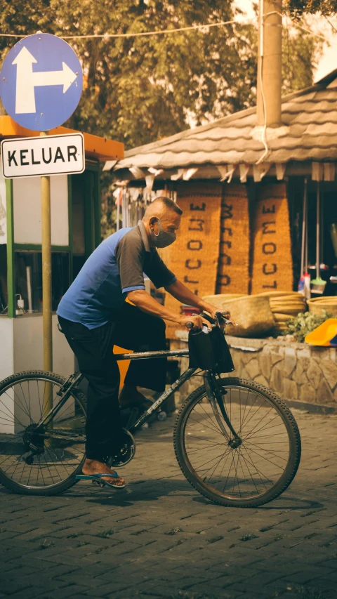 the man is fixing his bicycle before riding it