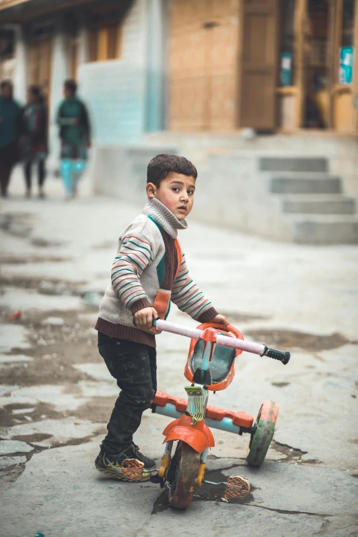 a  riding on the back of a red bicycle