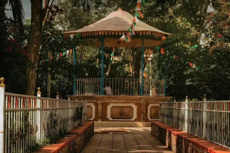 a beautiful gazebo and bridge surrounded by many trees