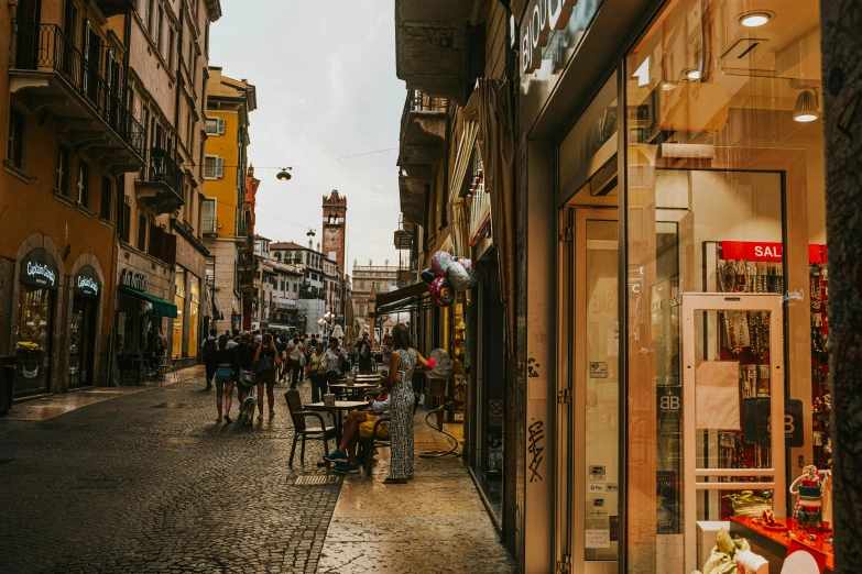 a busy street at dusk with shops in the distance