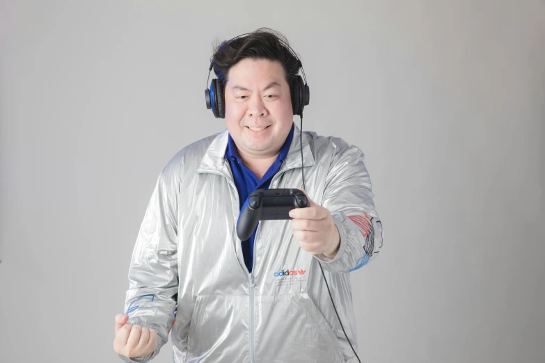 a man wearing headphones and a silver jacket