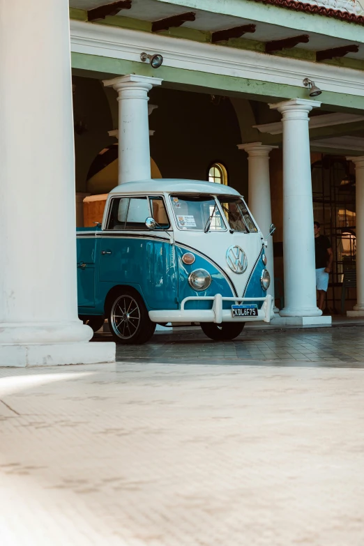 a blue and white car parked inside of a building