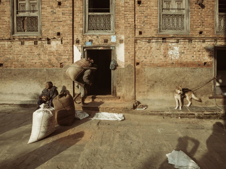 a man is leading an elephant out of a door