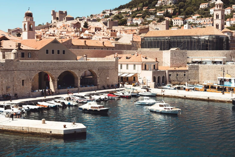 a harbor with a few boats and buildings on the cliffs