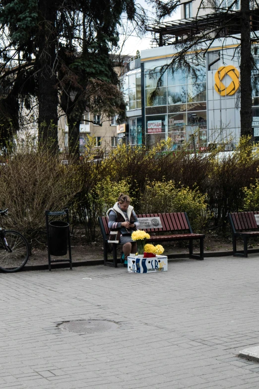 a man sitting on a bench with fruit on top of it