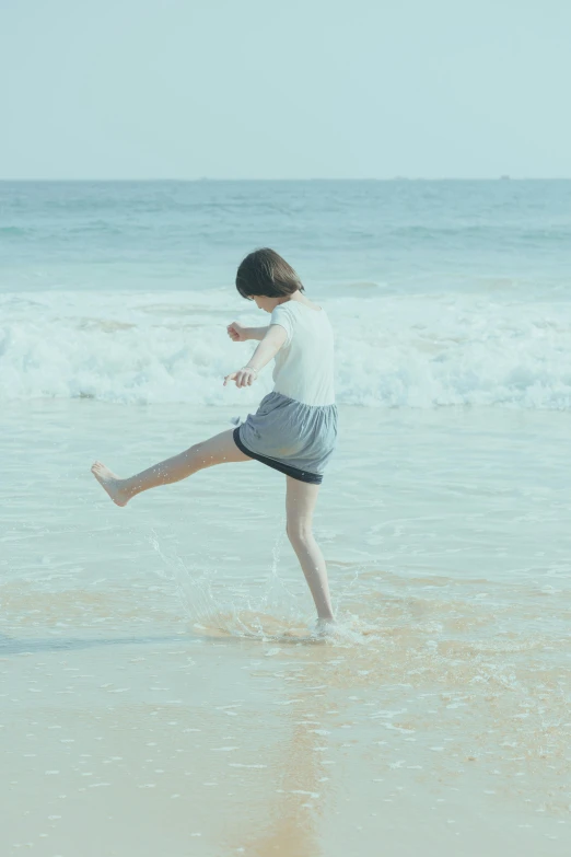 a  is running across the sand on a beach