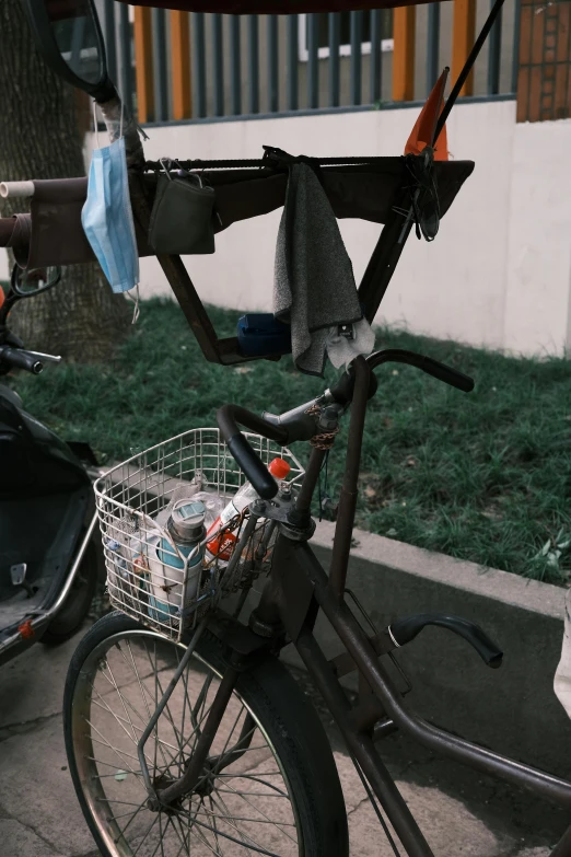 a bicycle  to a pole next to a building