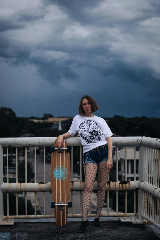 the woman is standing on a balcony holding her skateboard