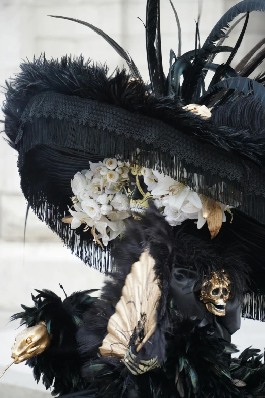 a large black hat with flowers and feathers