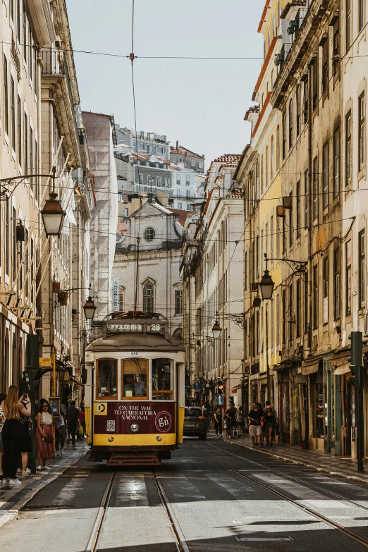 trolley on the street in the city with people waiting