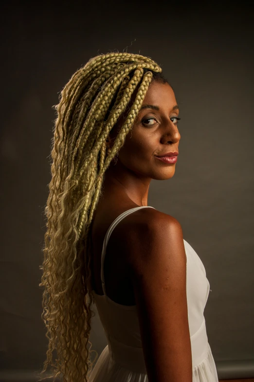 a woman with blond hair is posing for the camera