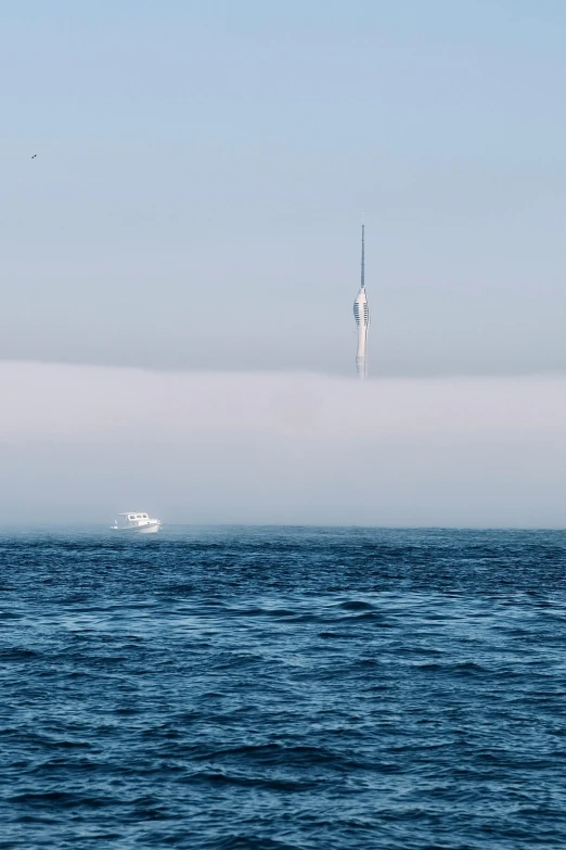 boat sailing in an ocean on a hazy day