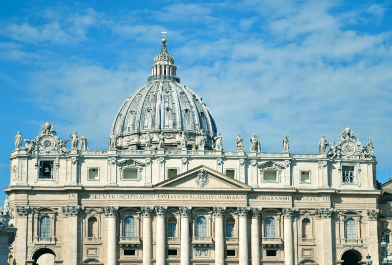 large white building with some statues and statues on top