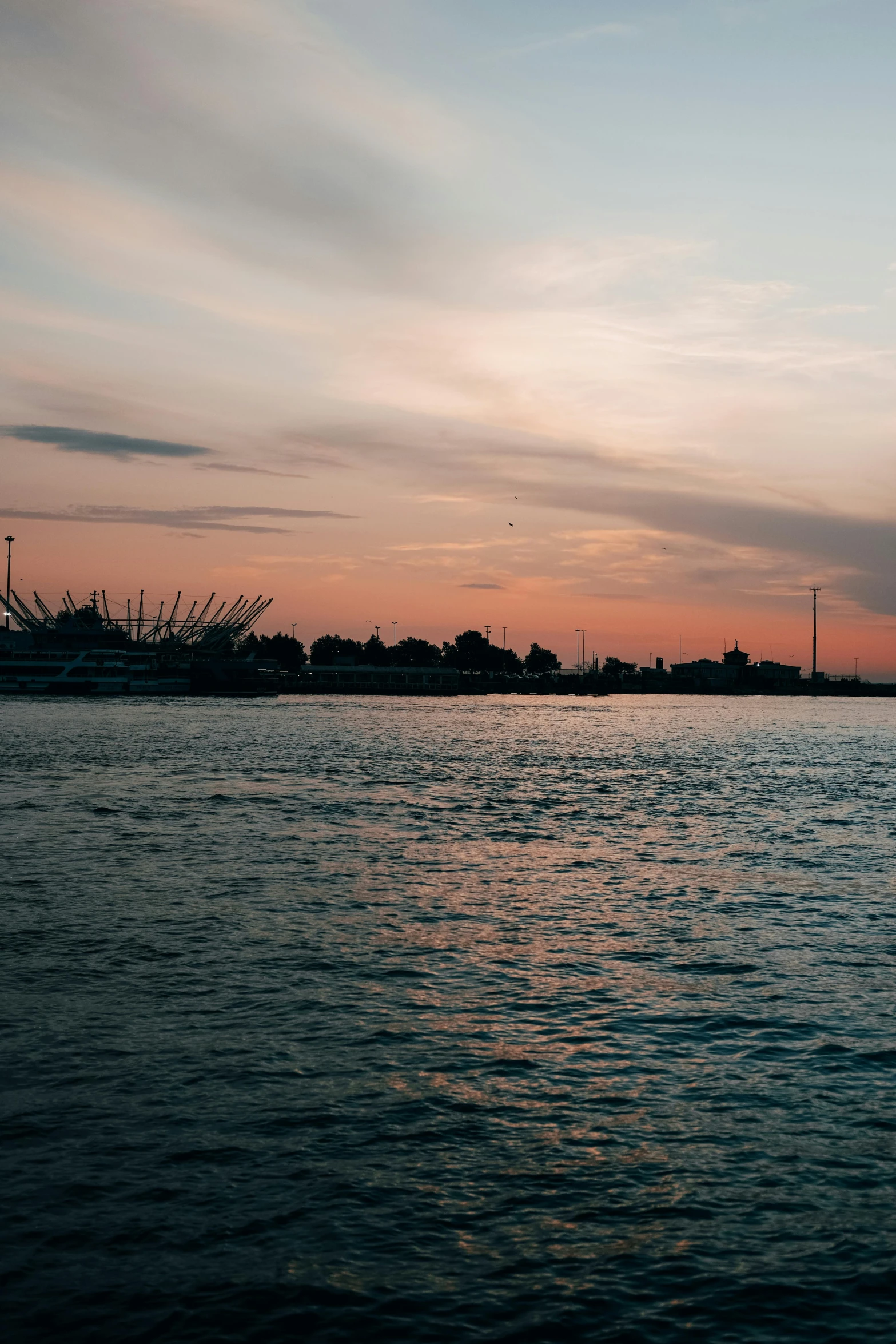 the boat floats across the body of water