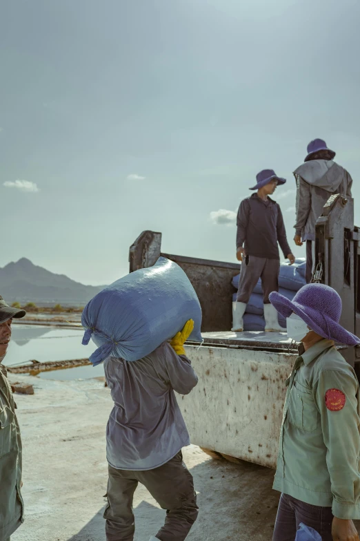 a group of people standing on top of a boat