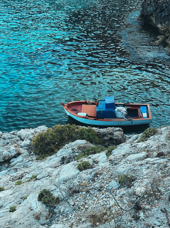 a small boat is tied up on the shore