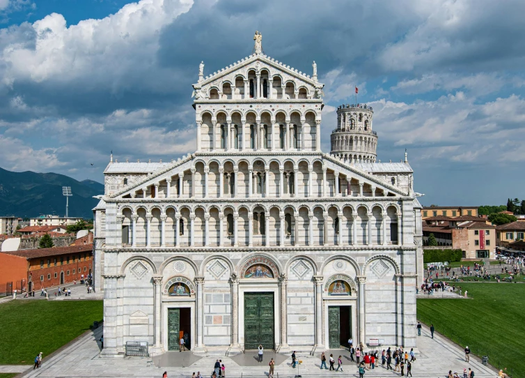 a large cathedral type structure sitting next to a green field